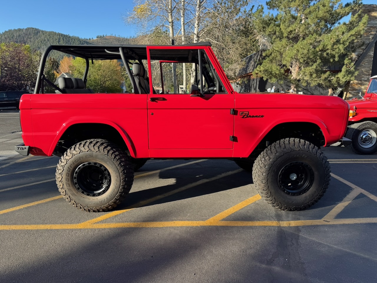 A bright red classic Ford Bronco at a Ketchum gathering